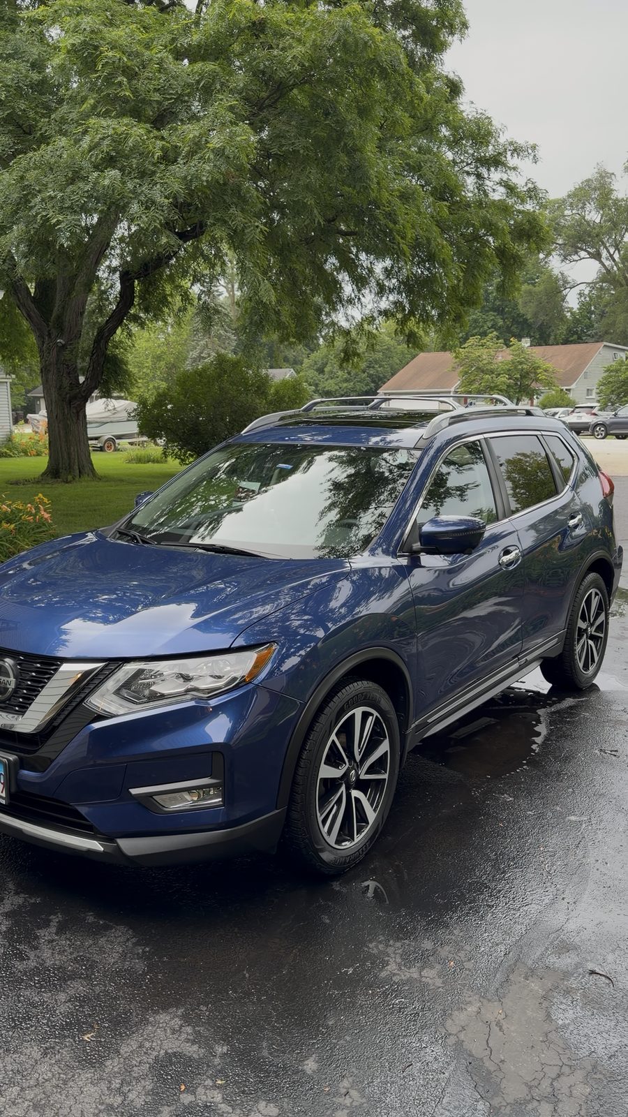 Blue Nissan Rogue side profile with glossy paint after a driveway mobile detail