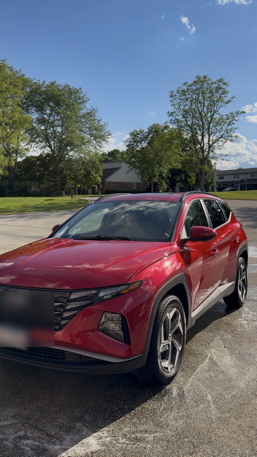 Red Hyundai Tucson shining in the sun after an on-site mobile detail