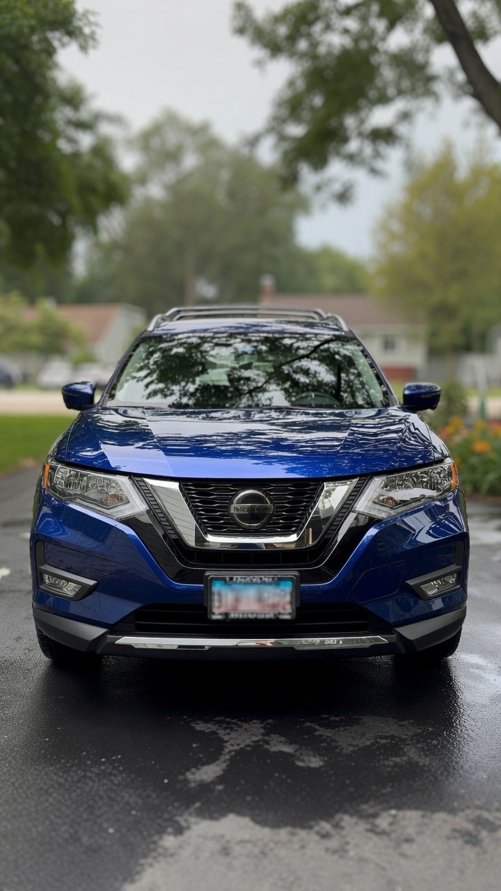 Deep blue Nissan Rogue gleaming in a driveway after a full mobile detail by Revive Detail Lab